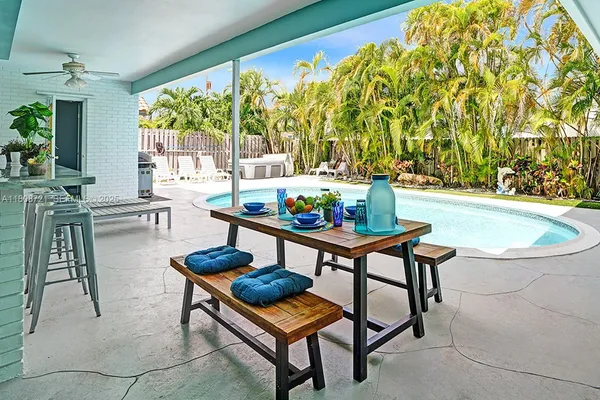 a living room with a table and chairs