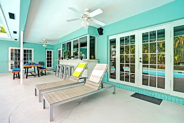 a swimming pool with chairs and table