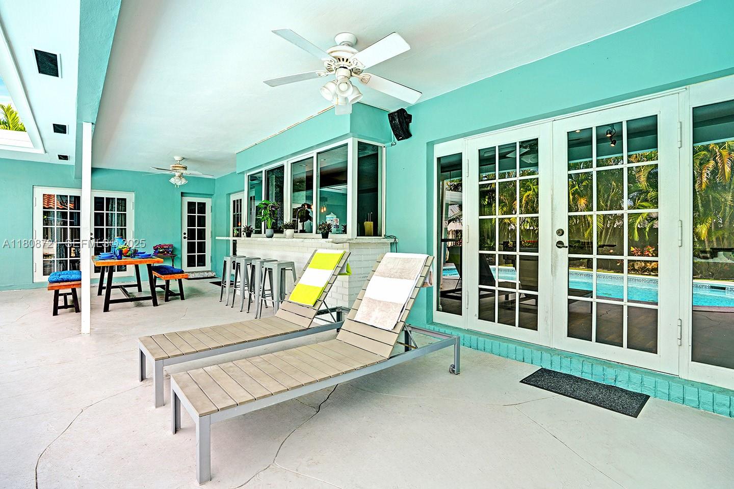 1245 Wiley Street Hollywood, FL 33019 - Photo 36 of 43 a swimming pool with chairs and table