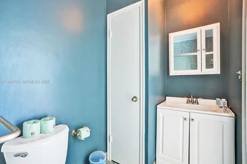 a bathroom with a sink toilet and a mirror