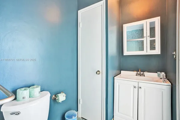 a bathroom with a sink toilet and a mirror