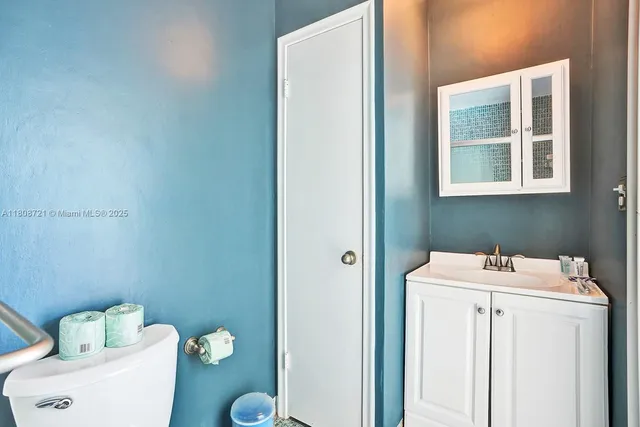 a bathroom with a sink toilet and a mirror