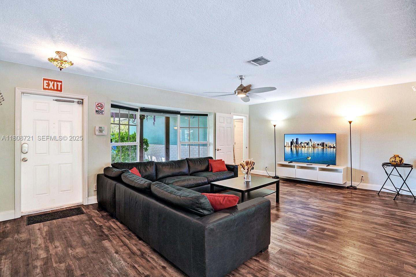 1245 Wiley Street Hollywood, FL 33019 - Photo 7 of 43 a living room with furniture and a flat screen tv