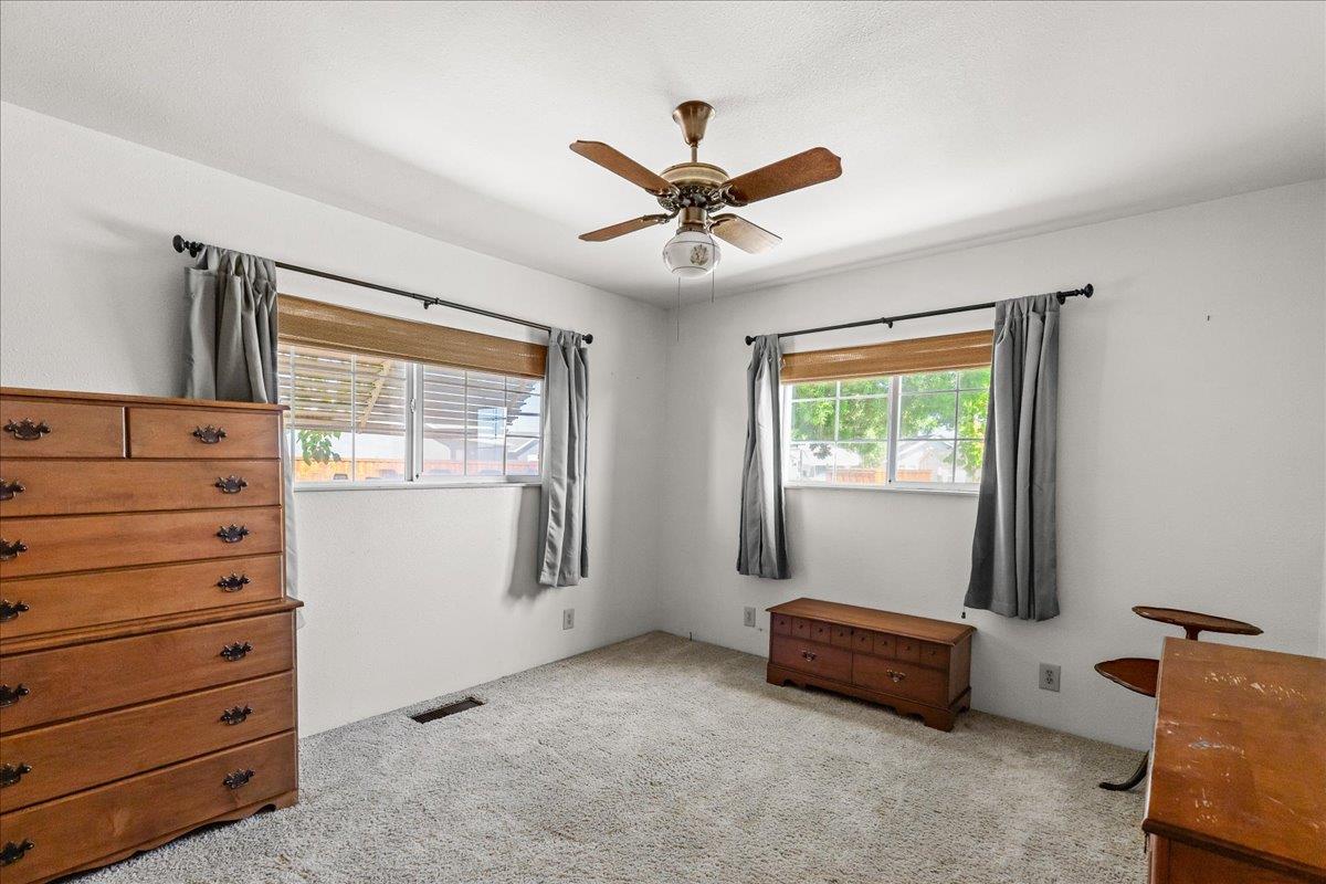 4701 Lone Tree Road Valley Home, CA 95361 - Photo 30 of 59 a view of room with window and a ceiling fan