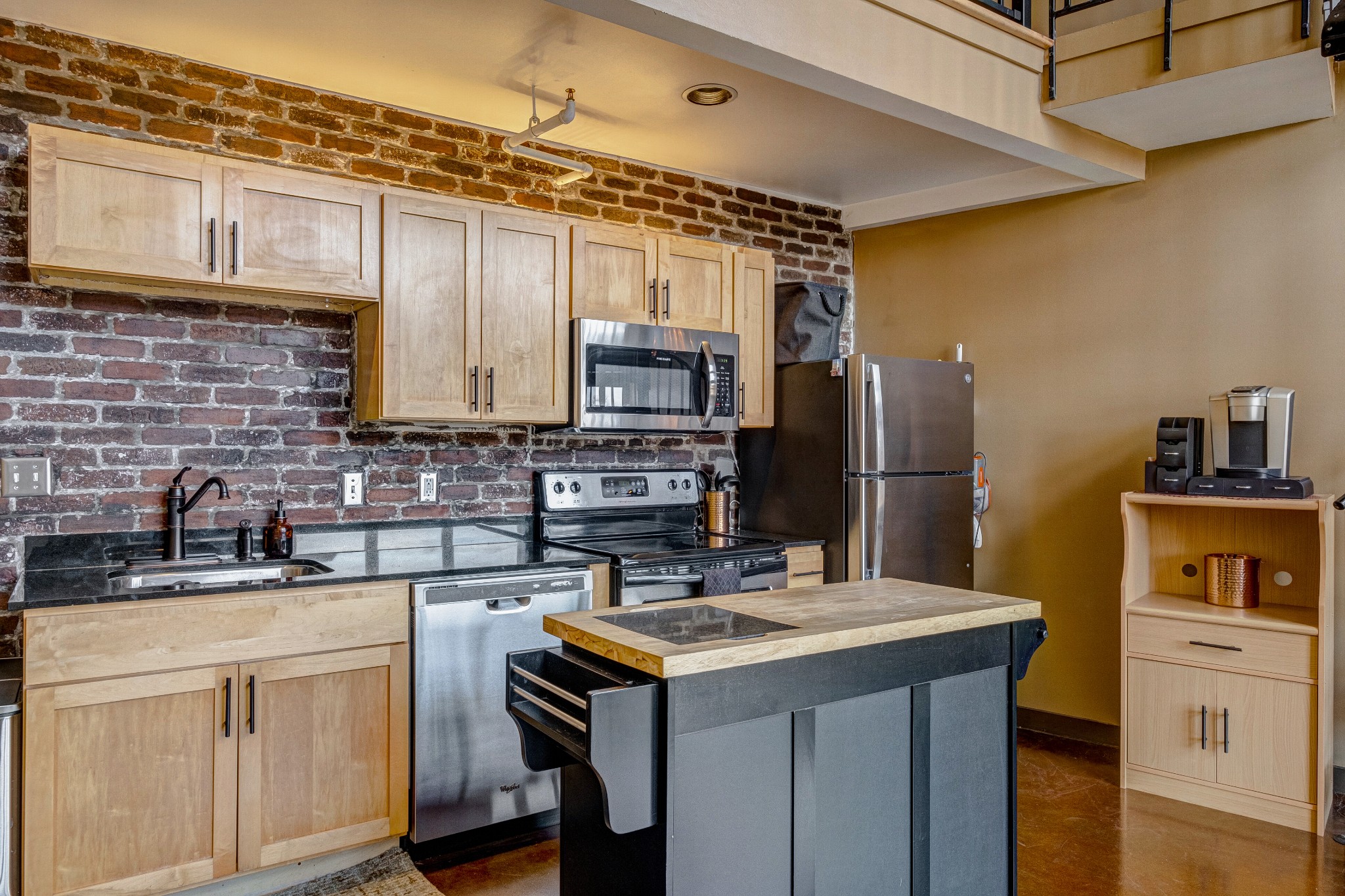 1400 Rosa L Parks Boulevard, Unit 320 Nashville, TN 37208 - Photo 13 of 34 a kitchen with stainless steel appliances a sink stove refrigerator and cabinets
