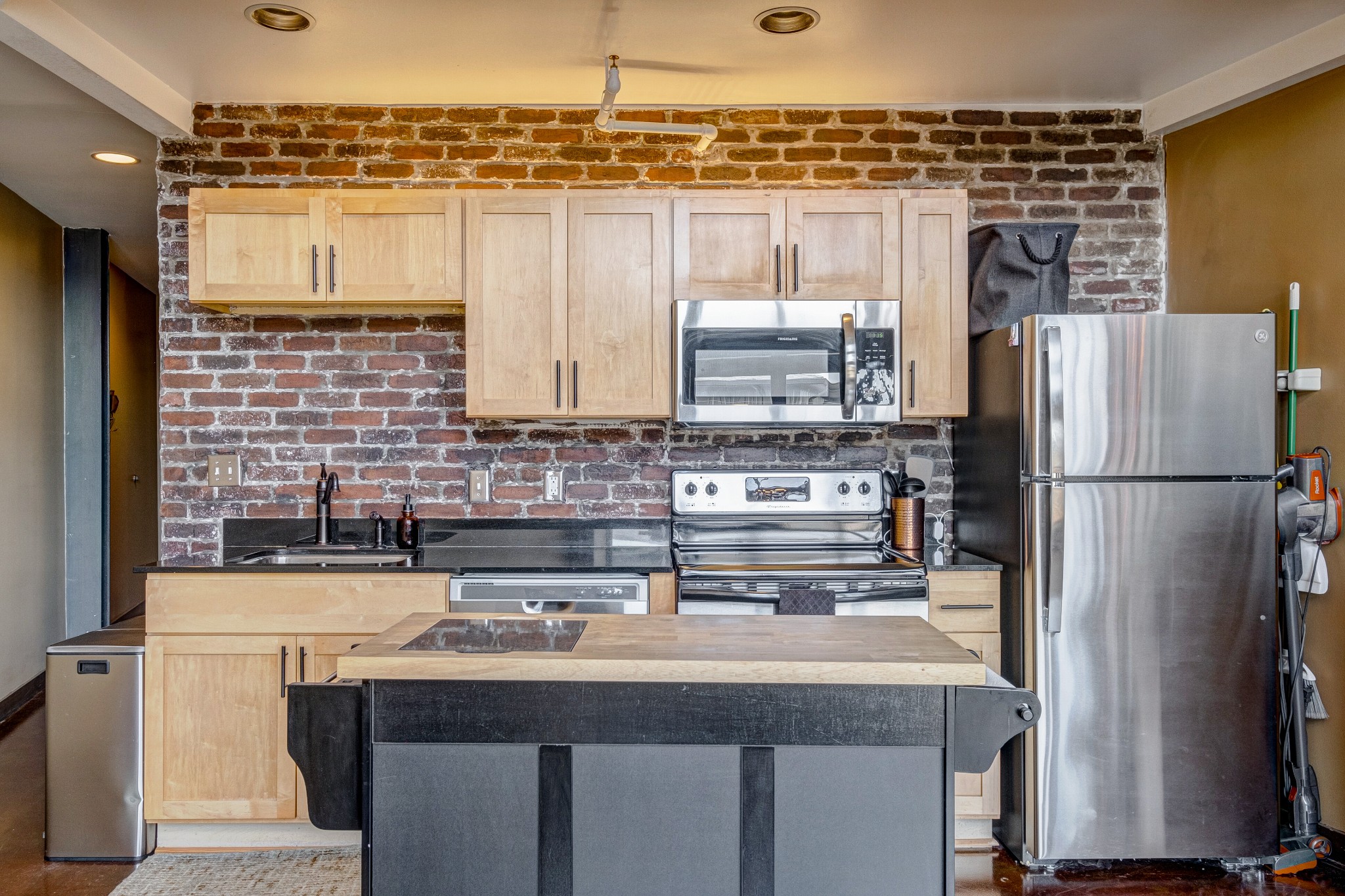 1400 Rosa L Parks Boulevard, Unit 320 Nashville, TN 37208 - Photo 14 of 34 a kitchen with stainless steel appliances a sink and a refrigerator