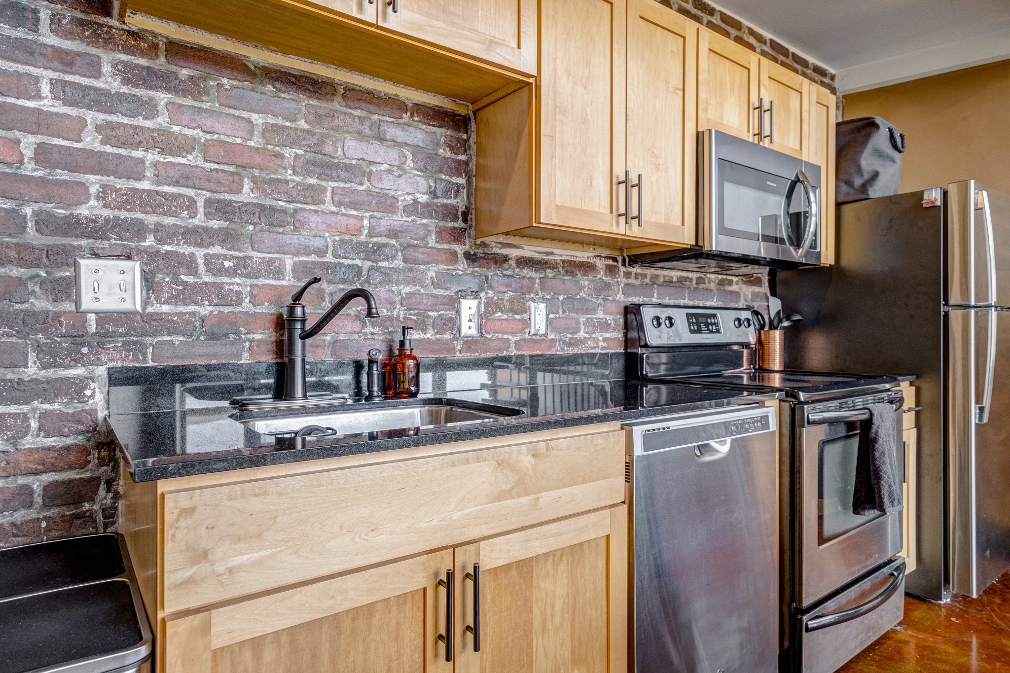 1400 Rosa L Parks Boulevard, Unit 320 Nashville, TN 37208 - Photo 16 of 34 a kitchen with stainless steel appliances granite countertop a refrigerator stove and sink