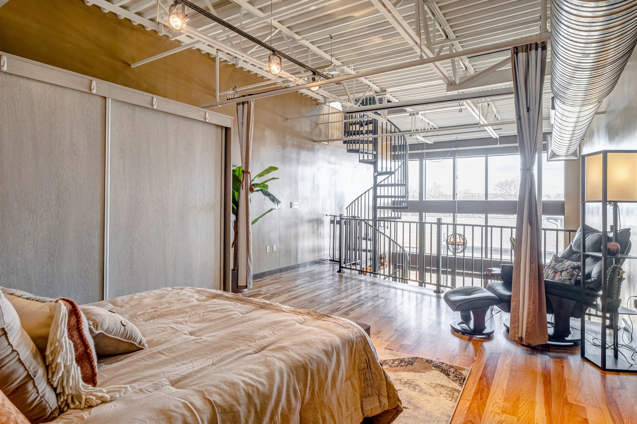 1400 Rosa L Parks Boulevard, Unit 320 Nashville, TN 37208 - Photo 25 of 34 a bedroom with a bed and a wooden floor