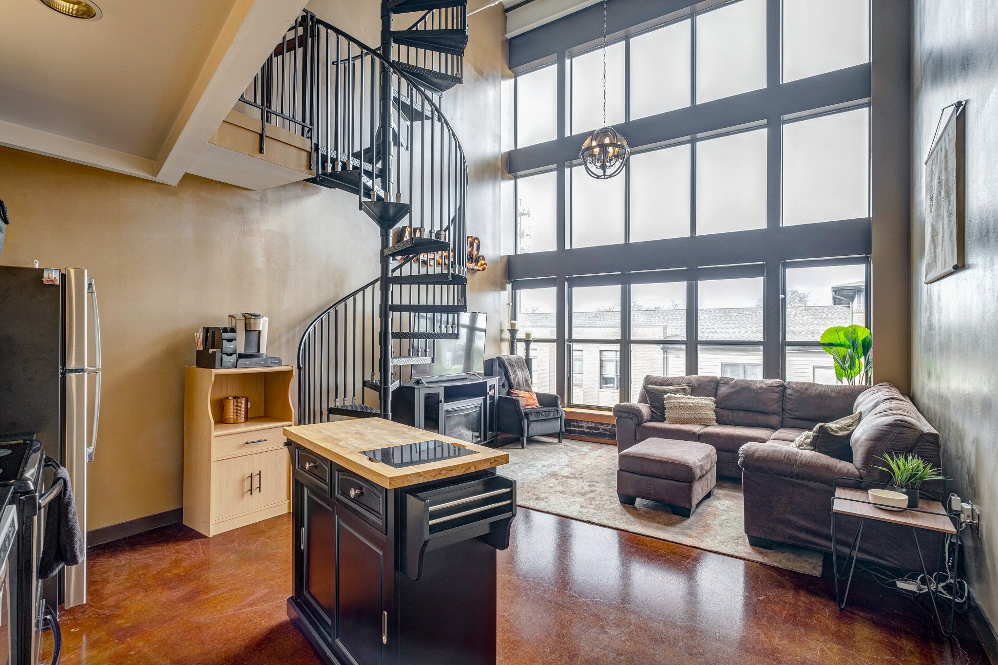 1400 Rosa L Parks Boulevard, Unit 320 Nashville, TN 37208 - Photo 5 of 34 a living room with furniture floor to ceiling window and a flat screen tv