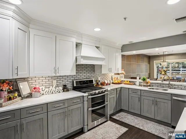 a kitchen with lots of counter top space a stove and cabinets