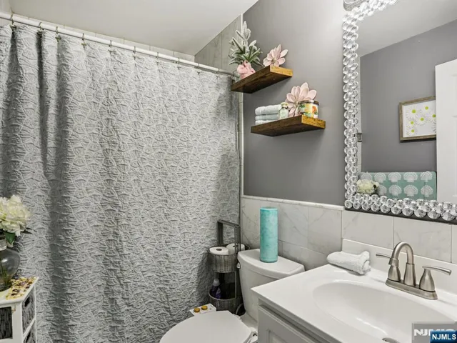 a living room with furniture ceiling fan and a window