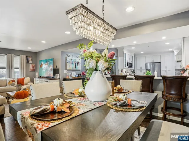 a dining hall with stainless steel appliances a dining table and chairs