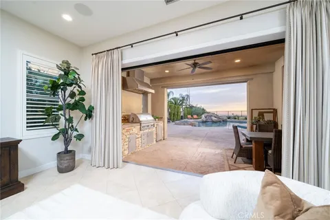a living room with furniture potted plant and a large window