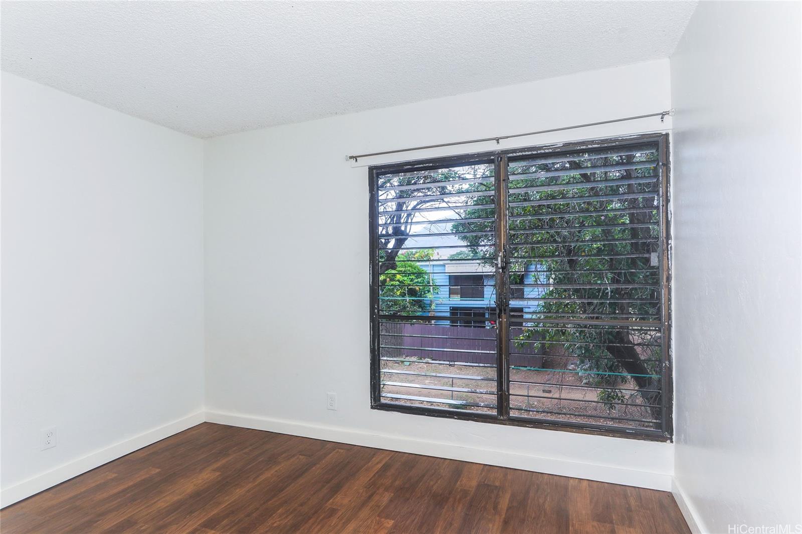 87-122 Helelua Street, Unit C204 Waianae, HI 96792 - Photo 11 of 19 a view of empty room with wooden floor and fan
