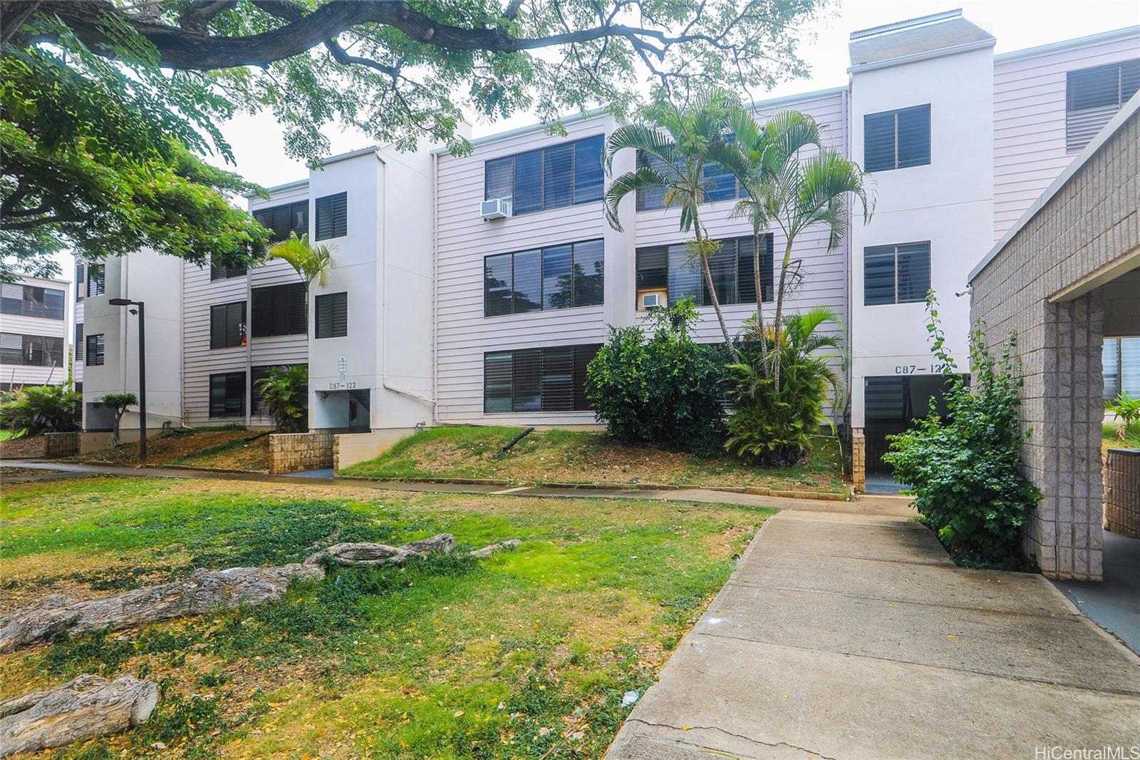 87-122 Helelua Street, Unit C204 Waianae, HI 96792 - Photo 17 of 19 a view of a house with a yard and plants