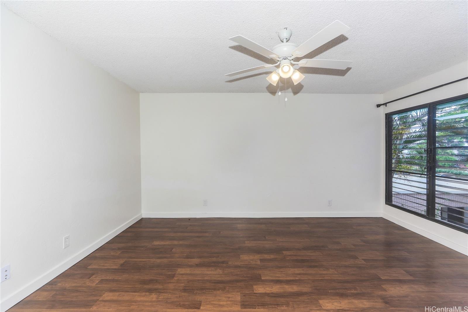87-122 Helelua Street, Unit C204 Waianae, HI 96792 - Photo 3 of 19 a view of an empty room with wooden floor and a window
