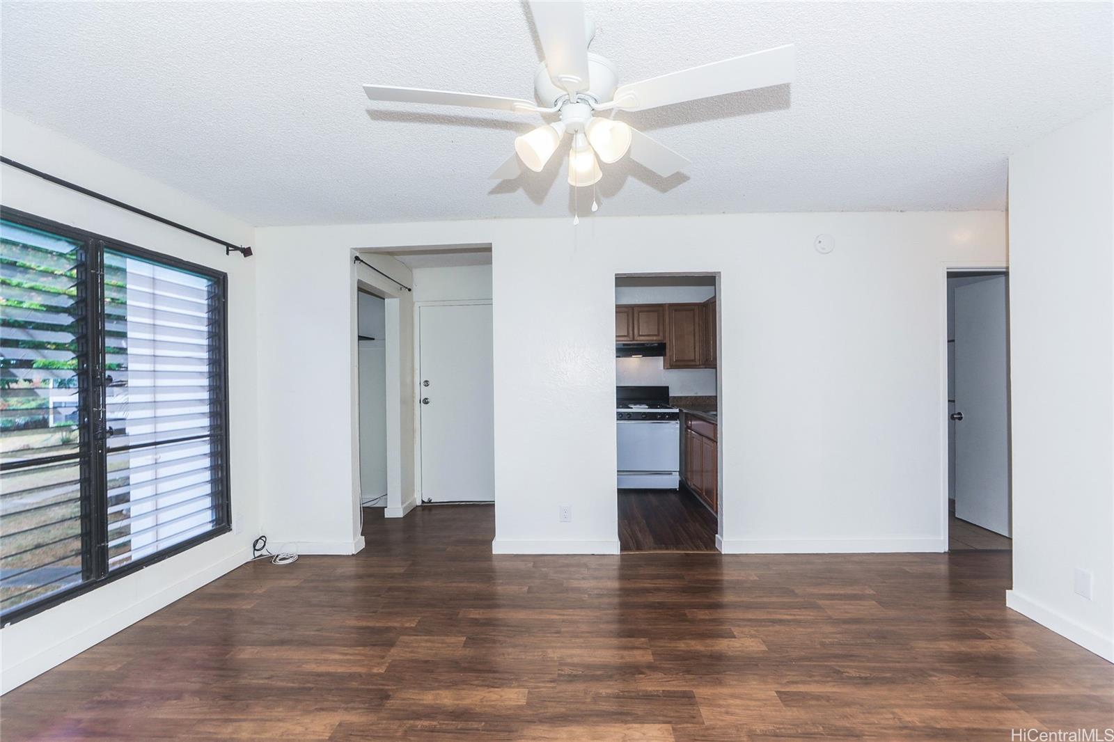 87-122 Helelua Street, Unit C204 Waianae, HI 96792 - Photo 4 of 19 a view of empty room with wooden floor and fan