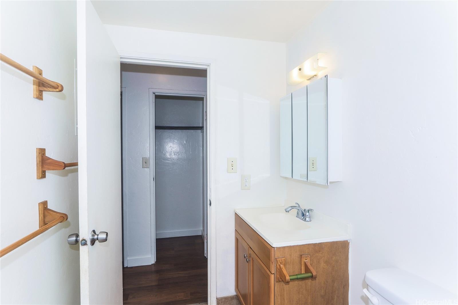 87-122 Helelua Street, Unit C204 Waianae, HI 96792 - Photo 9 of 19 a bathroom with a sink a mirror and a shower