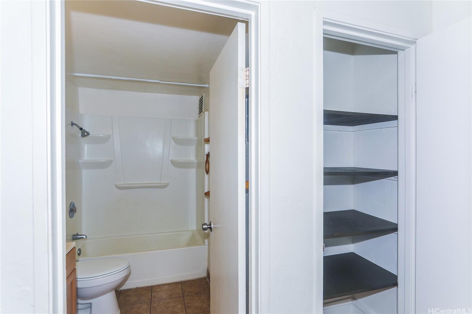 87-122 Helelua Street, Unit C204 Waianae, HI 96792 - Photo 10 of 19 a bathroom with a bathtub and toilet