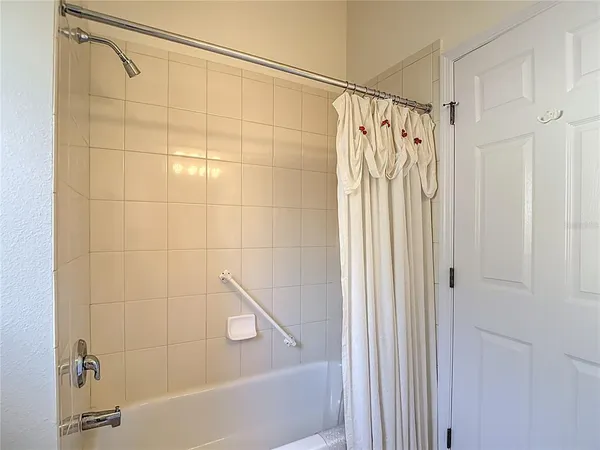 a bathroom with a shower and a tub