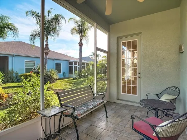 a view of a patio with chair and tables back yard of the house