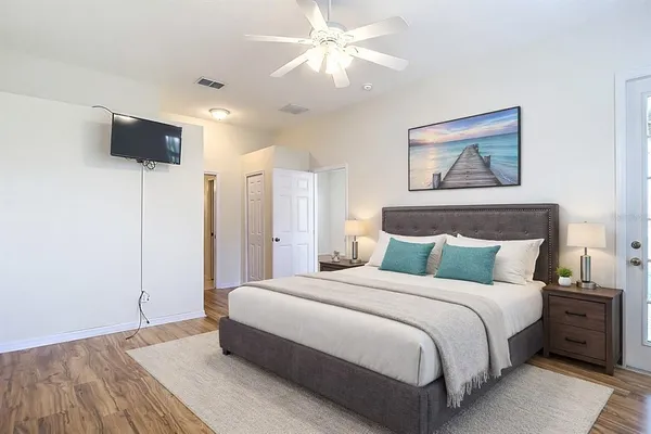 a bedroom with a bed and a tv