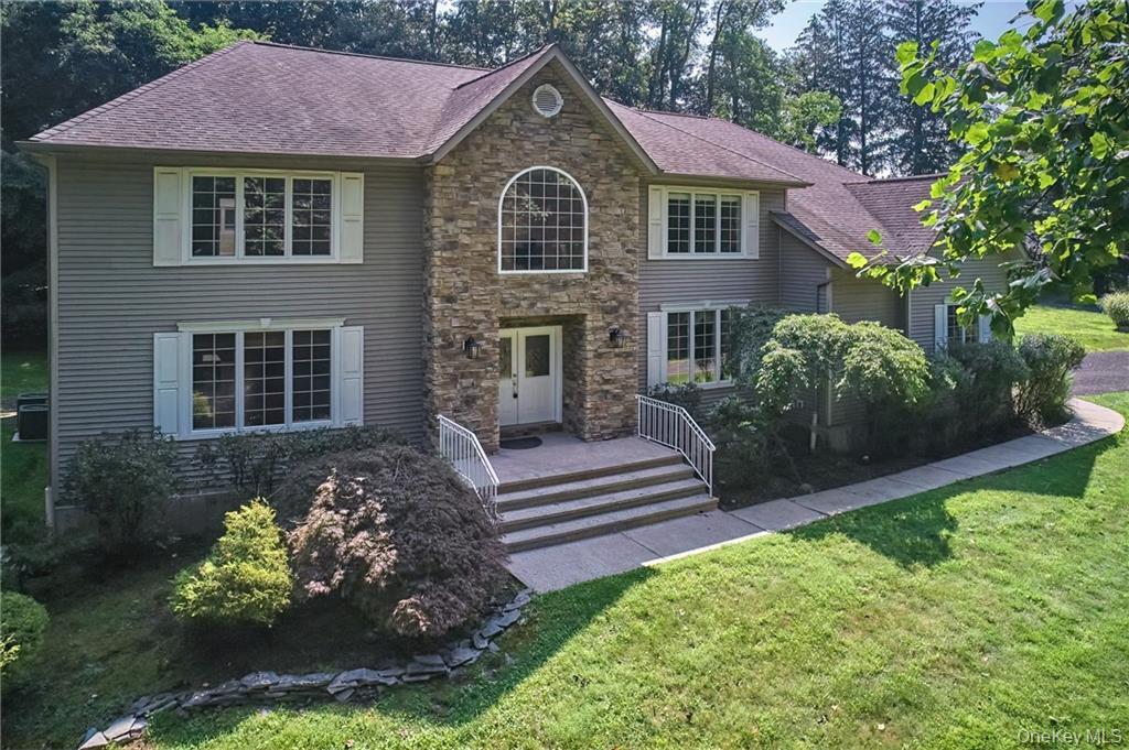a front view of a house with a yard and a garden