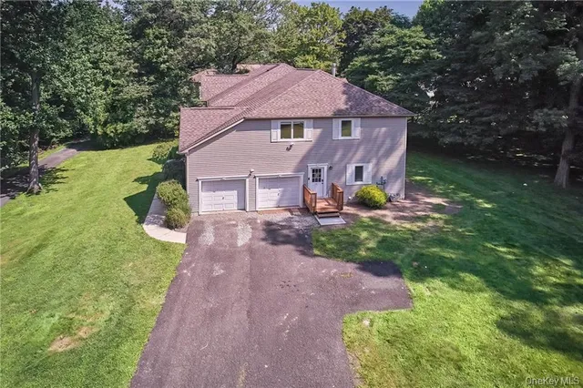 a aerial view of a house with yard and a garden