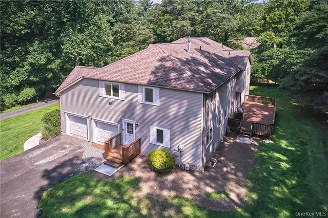 a view of a house with a yard and sitting area