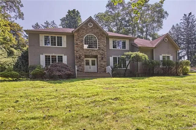 a front view of a house with a yard