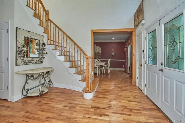 a view of entryway and hall with wooden floor