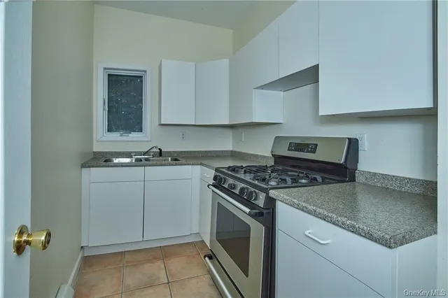 a kitchen with cabinets appliances and a sink