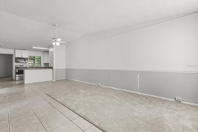 an empty room with a empty space and windows