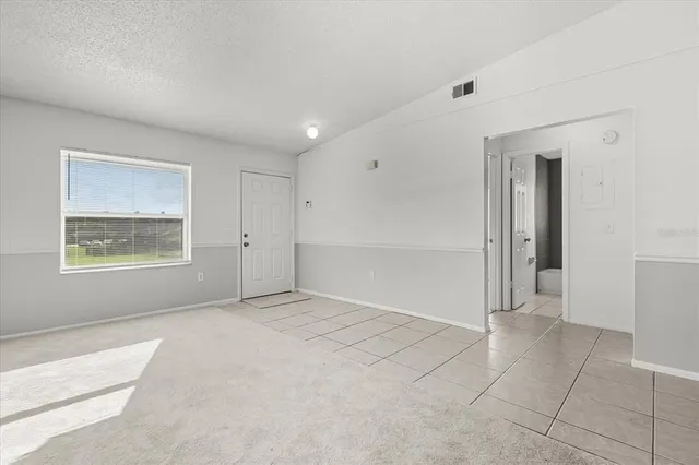 a view of kitchen with white cabinets
