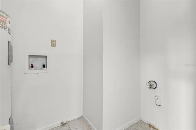 an empty room with a ceiling fan and a window