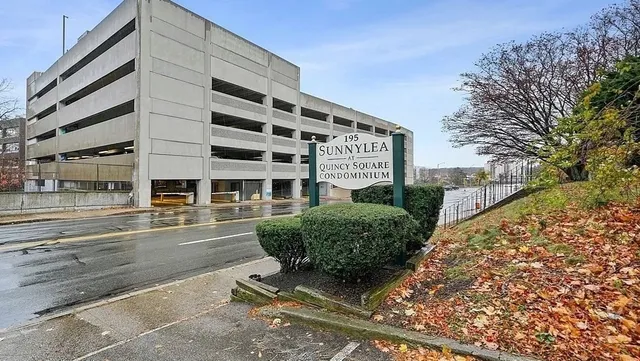 a front view of a building with a garden