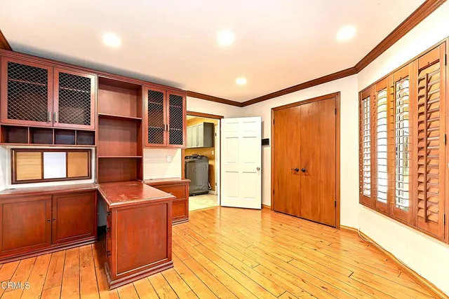 a view of a kitchen with furniture and wooden floor