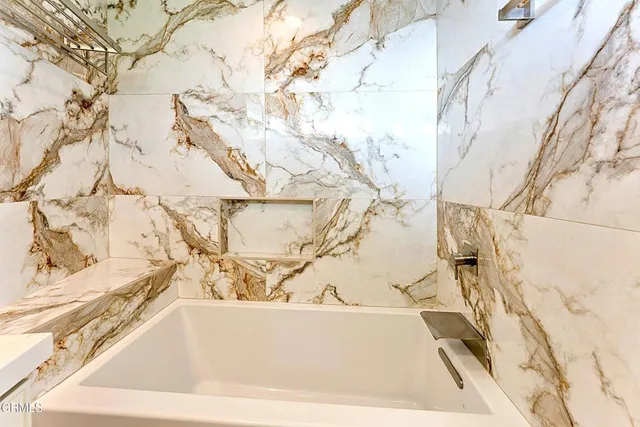 a white bath tub sitting in a bathroom