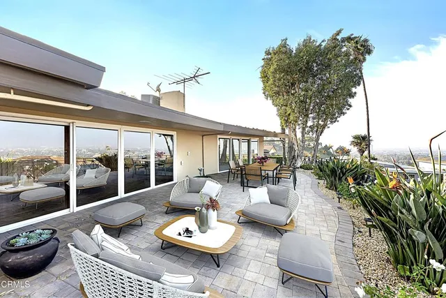 a outdoor space with patio the couches and potted plants with sky view
