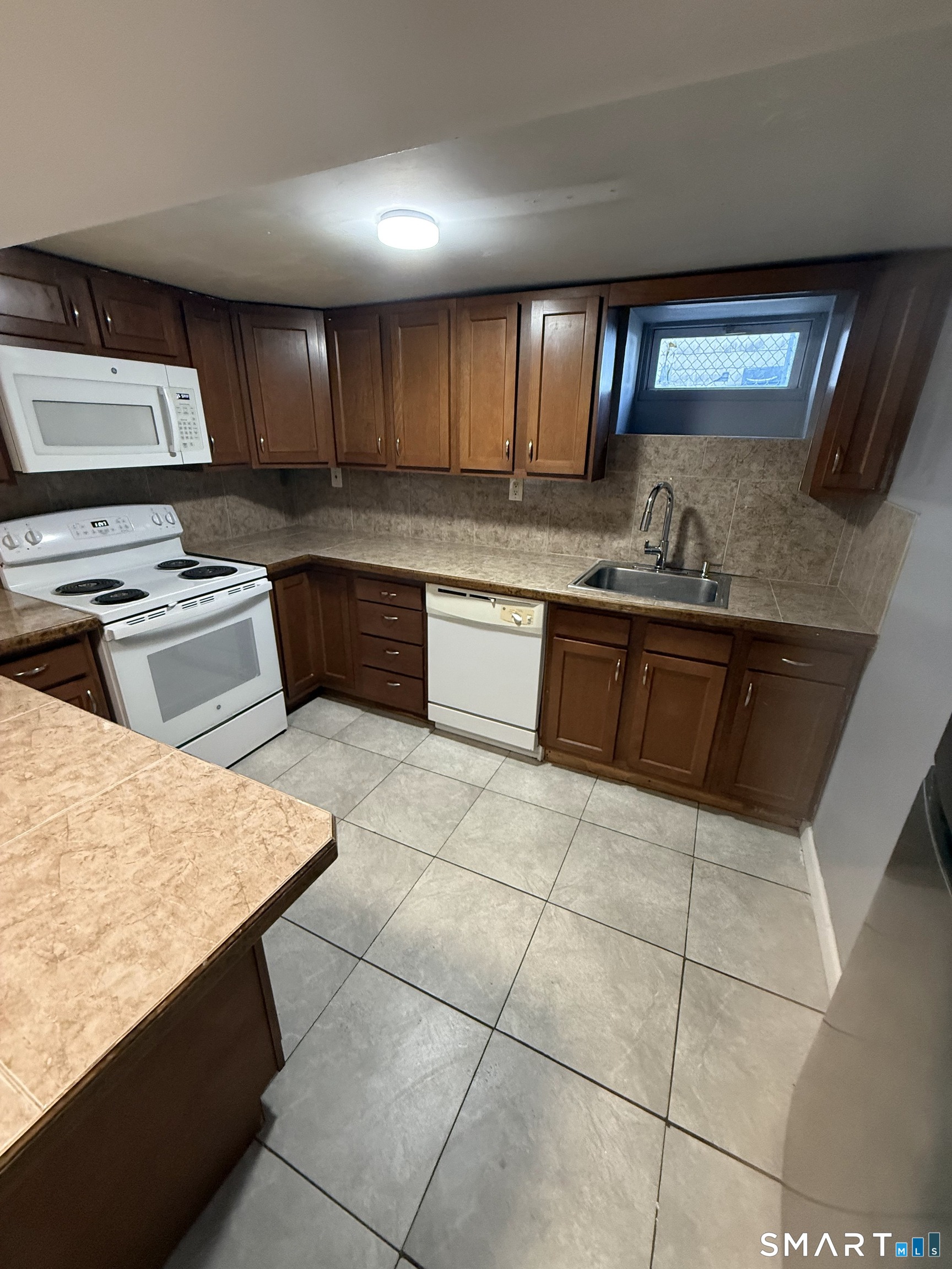 42 Cottage Street Bridgeport, CT 06605 - Photo 1 of 12 a kitchen with stainless steel appliances granite countertop a stove a sink and a microwave