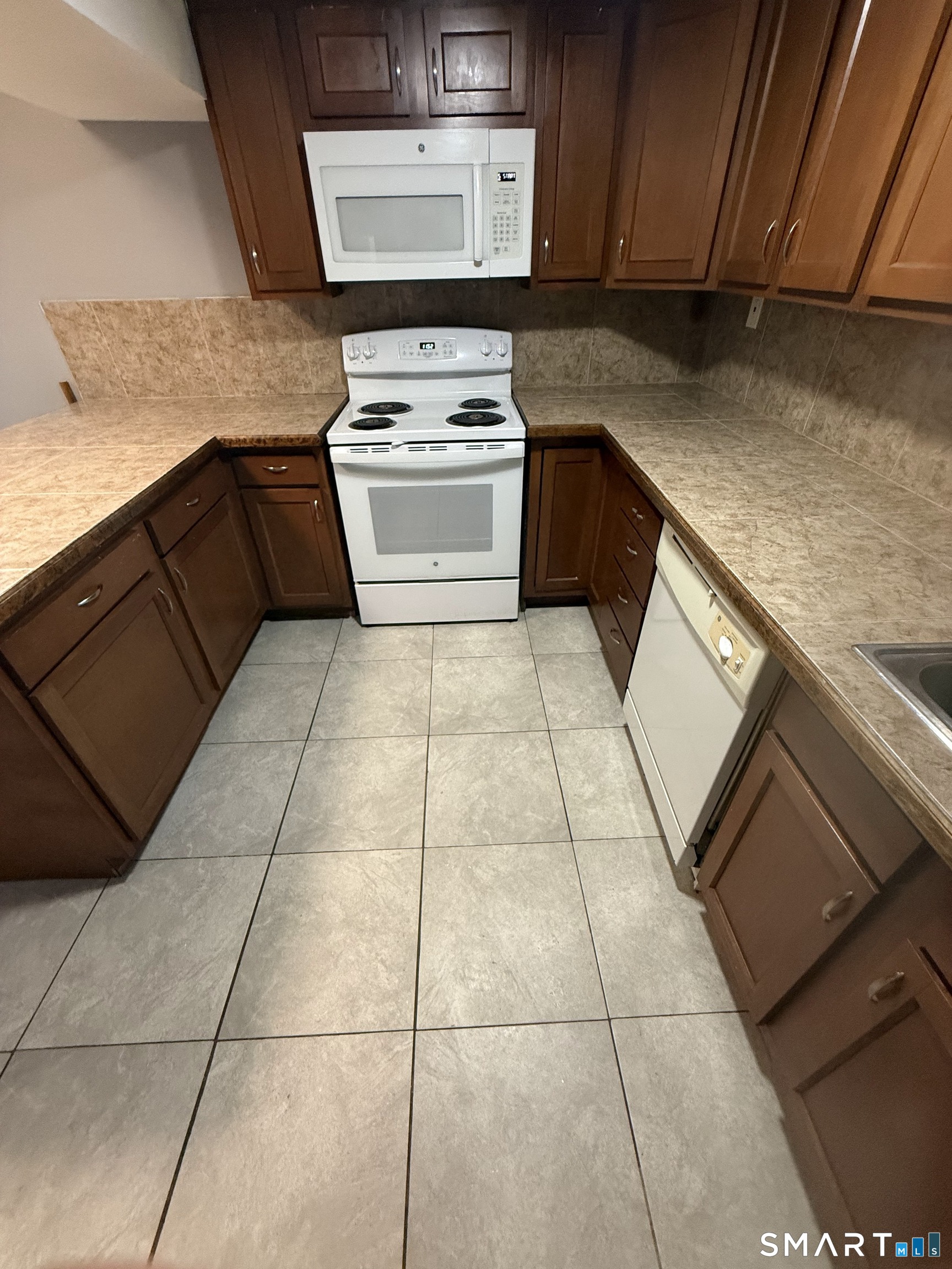 42 Cottage Street Bridgeport, CT 06605 - Photo 5 of 12 a kitchen with a stove top oven and cabinets