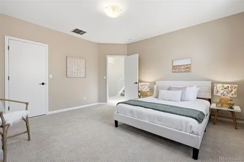 a bedroom with a bed lamp and a window
