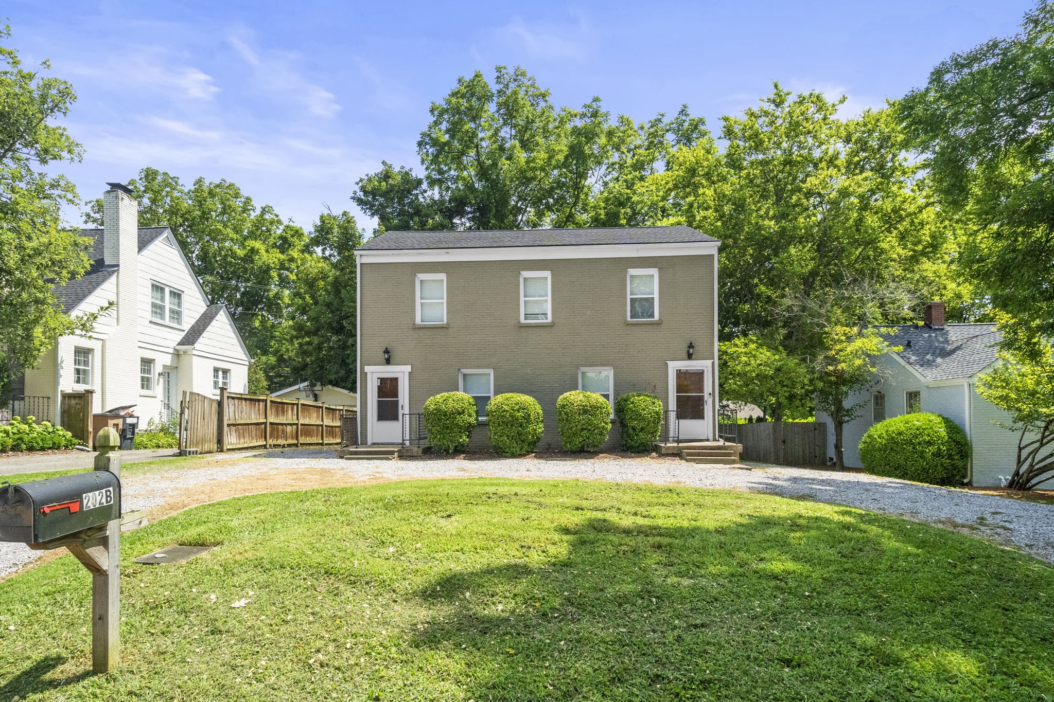 202 Cherokee Road Nashville, TN 37205 - Photo 1 of 35 a front view of a house with a yard and garage