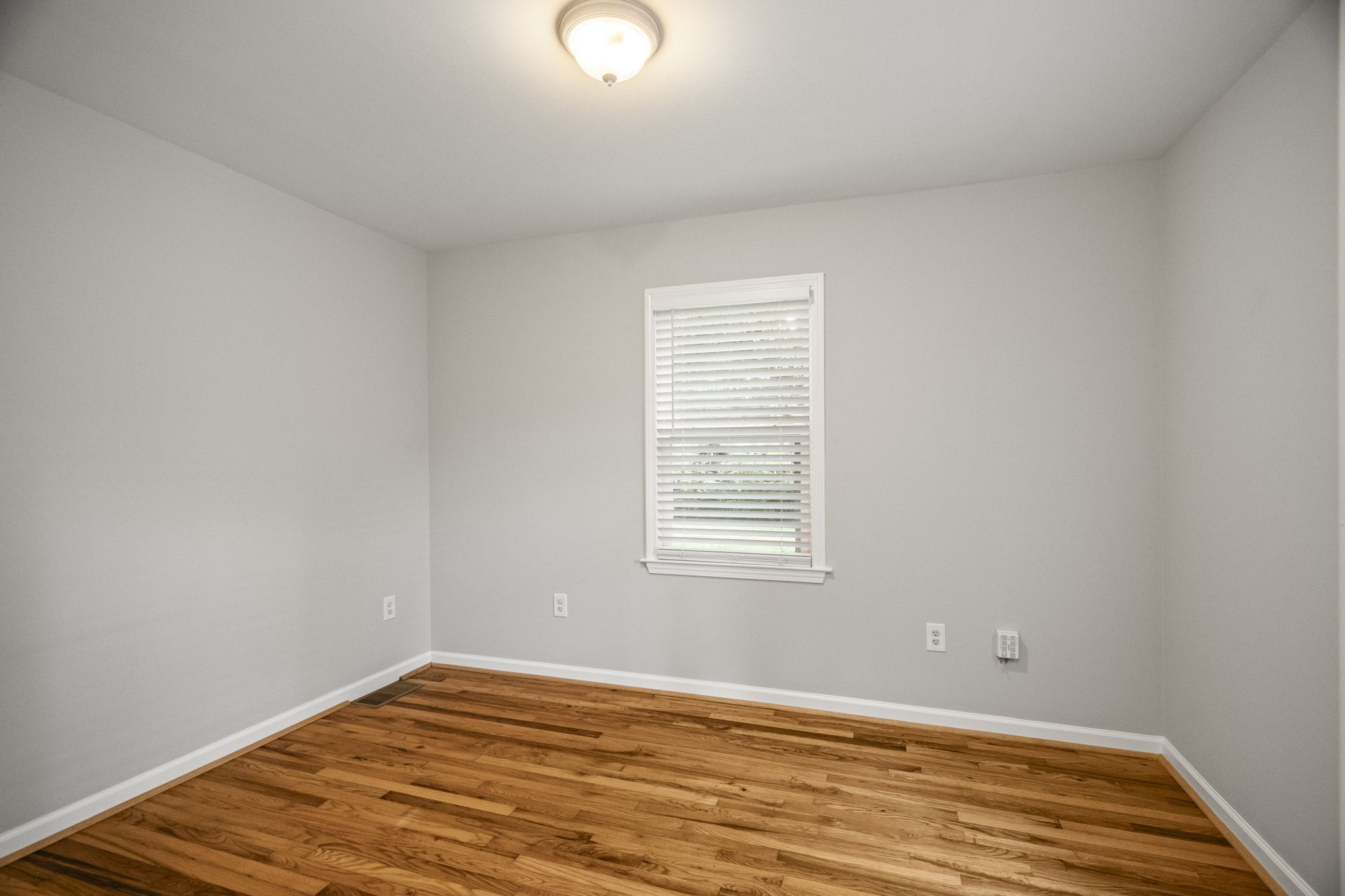 202 Cherokee Road Nashville, TN 37205 - Photo 16 of 35 a view of an empty room with wooden floor and a window