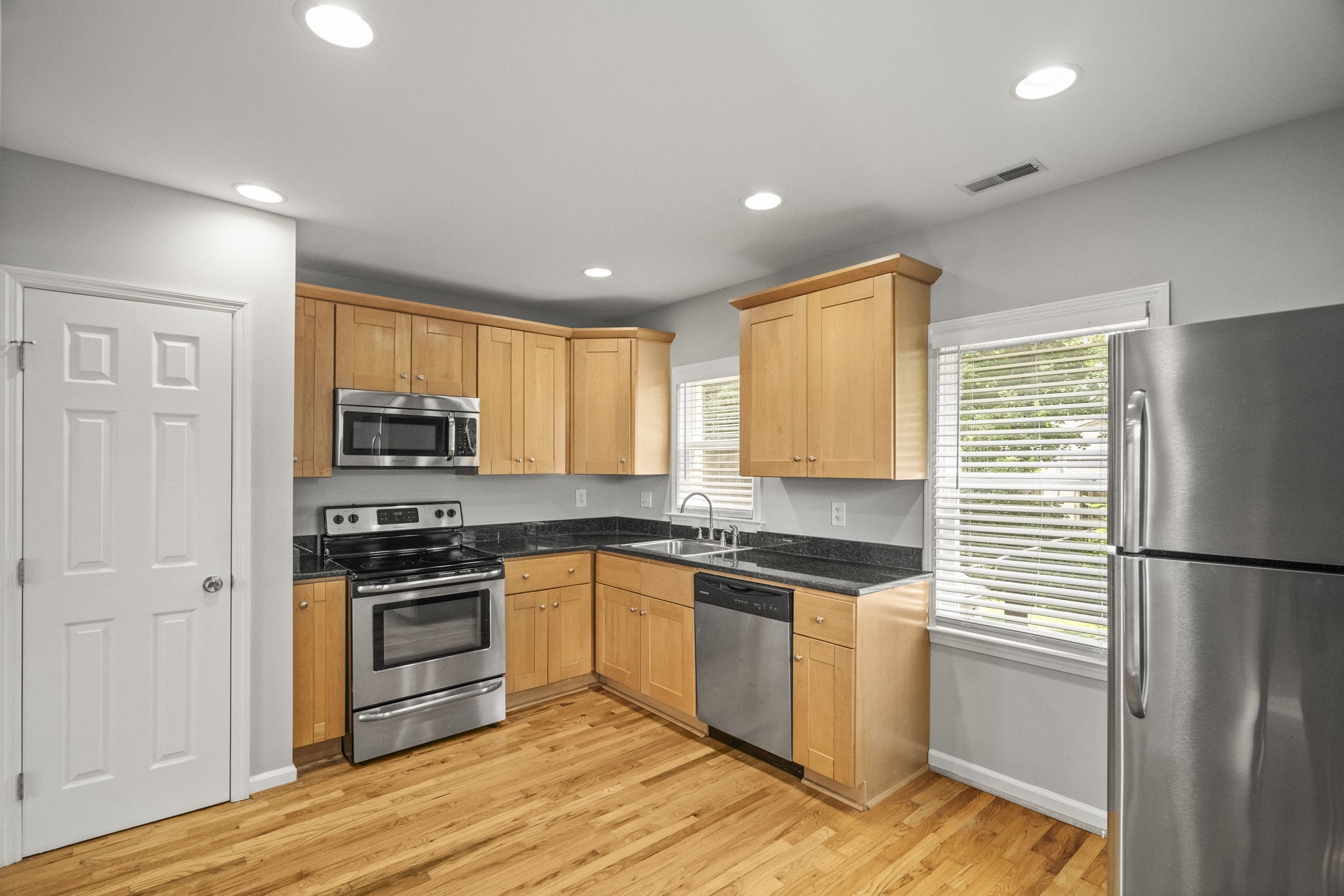 202 Cherokee Road Nashville, TN 37205 - Photo 22 of 35 a kitchen with stainless steel appliances granite countertop a refrigerator a stove top oven a sink and dishwasher with wooden floor