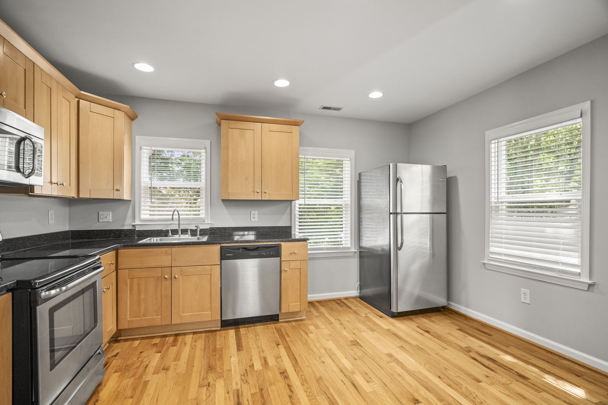 202 Cherokee Road Nashville, TN 37205 - Photo 23 of 35 a kitchen with granite countertop stainless steel appliances a refrigerator cabinets and wooden floor
