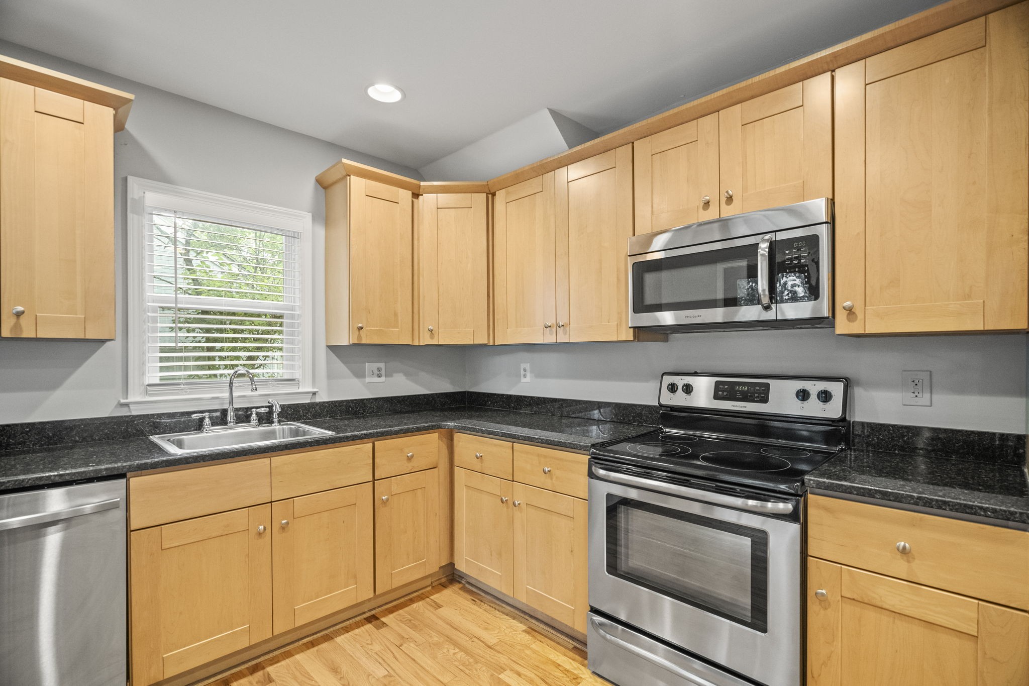 202 Cherokee Road Nashville, TN 37205 - Photo 7 of 35 a kitchen with stainless steel appliances granite countertop white cabinets granite counter tops and a window