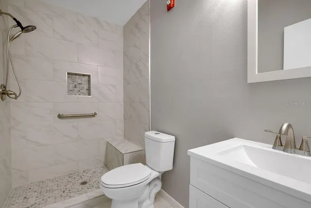 a white toilet sitting next to a bathroom sink