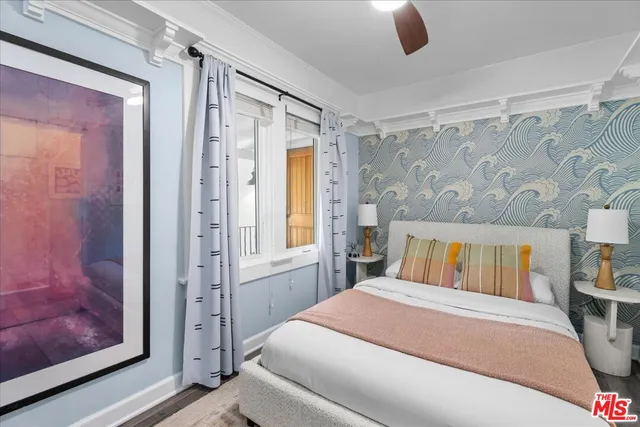 a bathroom with a bathtub shower sink vanity mirror and toilet