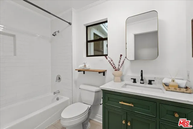 a bathroom with a bathtub a sink a mirror and a shower